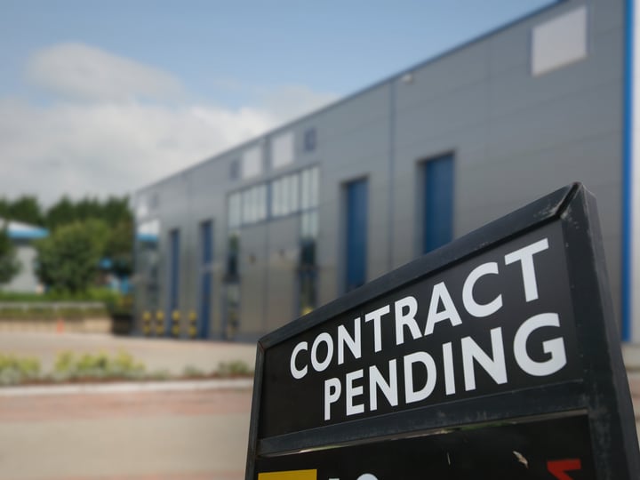 A CONTRACT PENDING sign outside a Dallas–Fort Worth commercial building