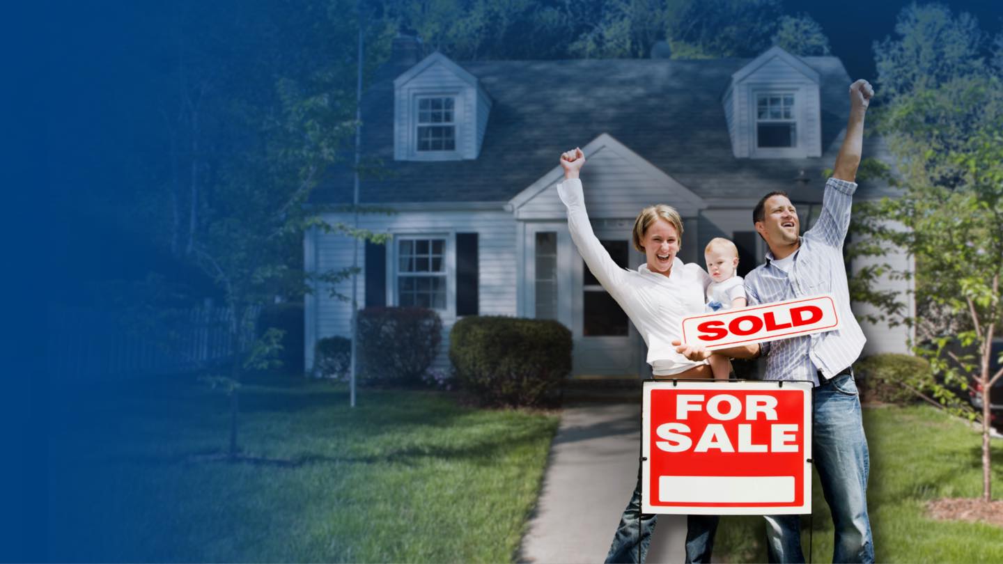 A family celebrating outside their Dallas–Fort Worth home beside a SOLD sign